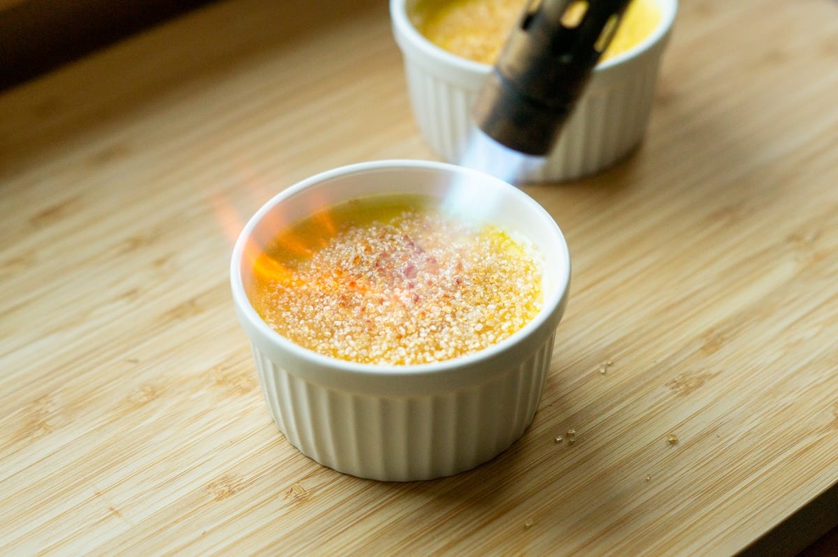 Caramelising the advocaat Crème Brûlée with a kitchen blowtorch