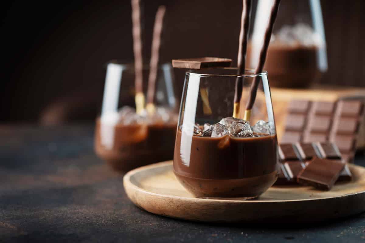 After Eight liqueur made in the Thermomix® in two glass bottles with a mint leaf