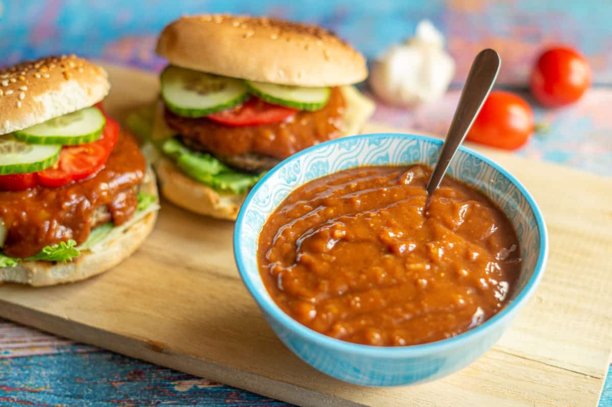 Spreading burger sauce over burgers