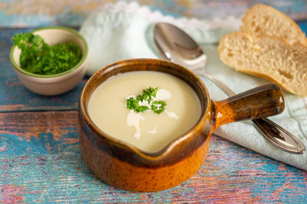 Creamy cauliflower soup made in the Thermomix® in a bowl, garnished with parsley