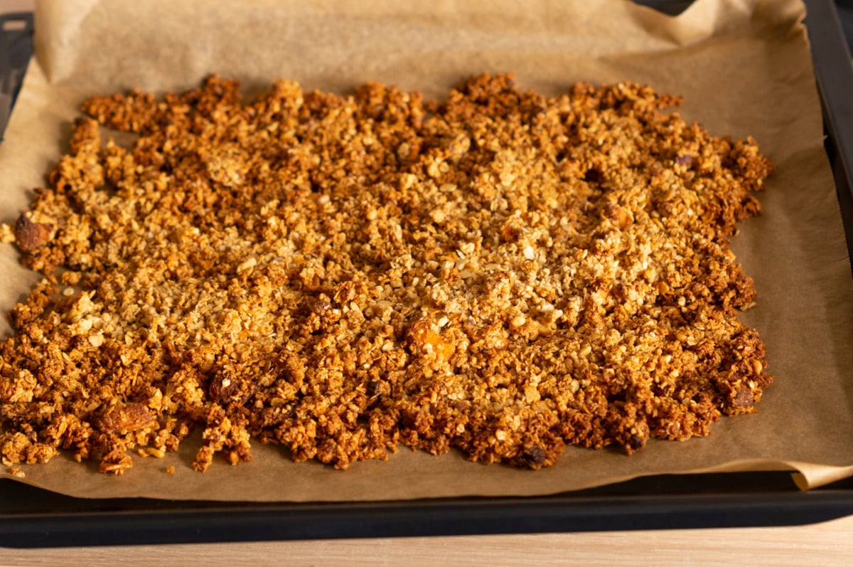 Crumbling the Christmas granola after baking