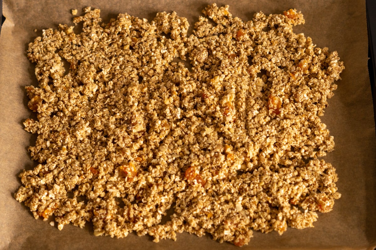 Spreading the granola evenly on the baking tray