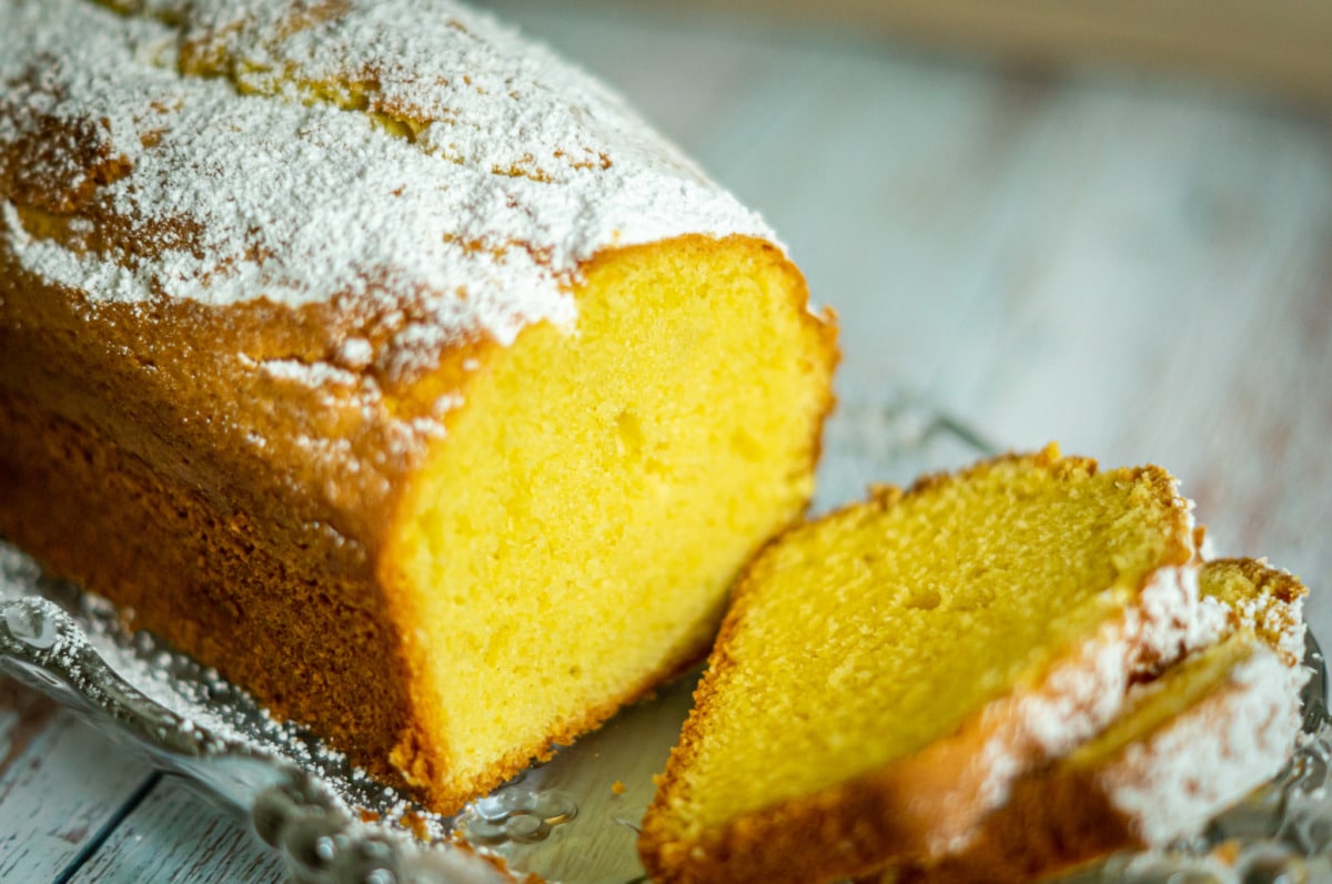 Classic pound cake made with the Thermomix®, sliced on a cake plate