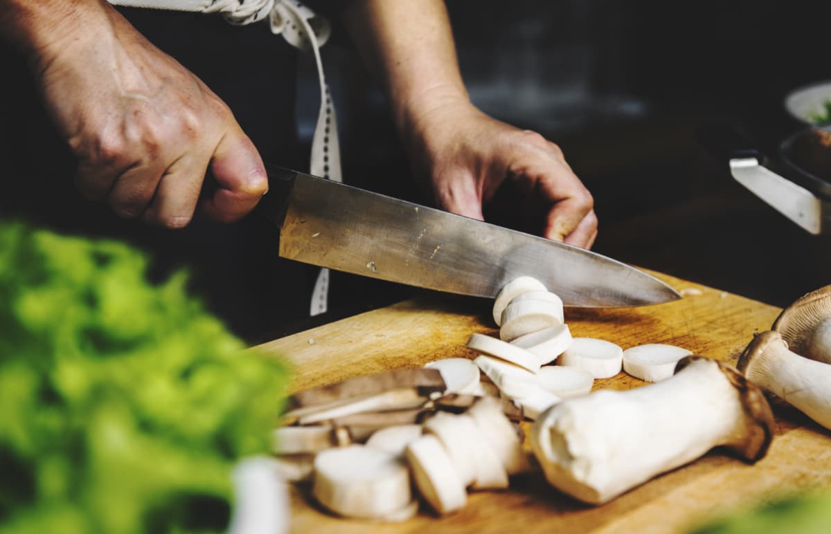 Cleaning fresh mushrooms and cutting them into pieces for the cream soup