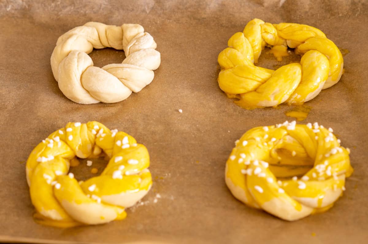 Brushing Easter wreath rolls with egg yolk