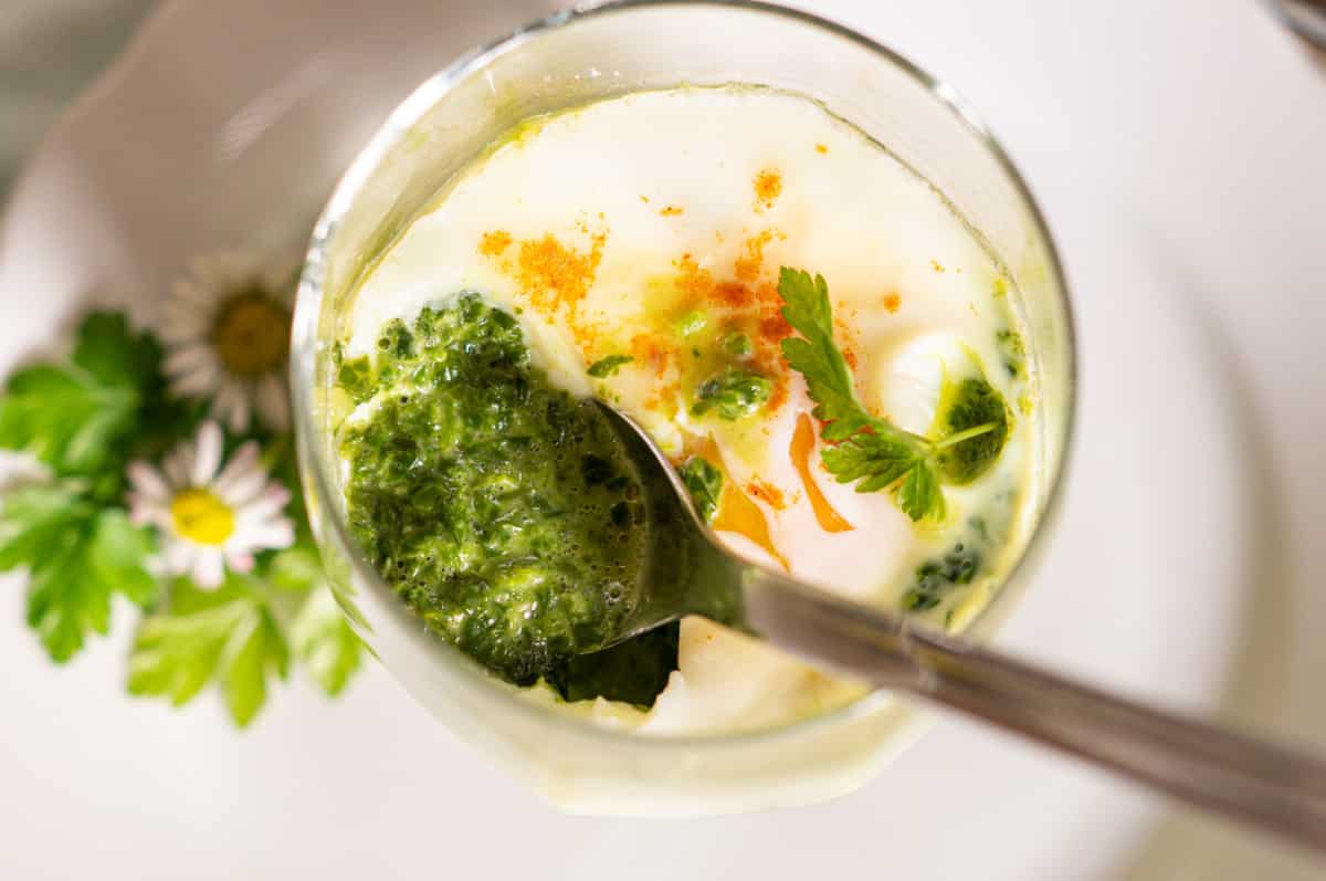 Steamed eggs in a glass with spinach