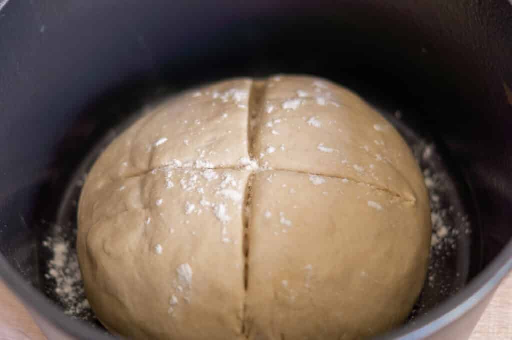 Scoring the bread dough in the casserole dish