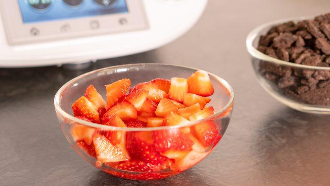 Quartering fresh strawberries for the layered dessert