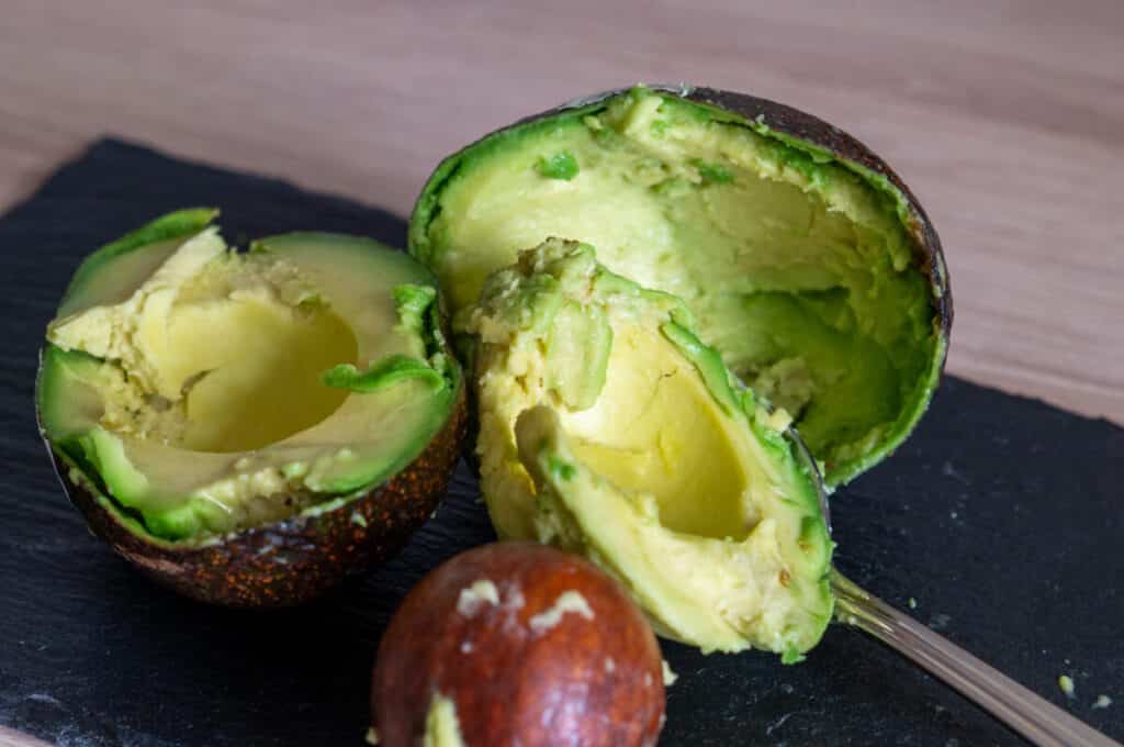 Removing avocado flesh with a spoon