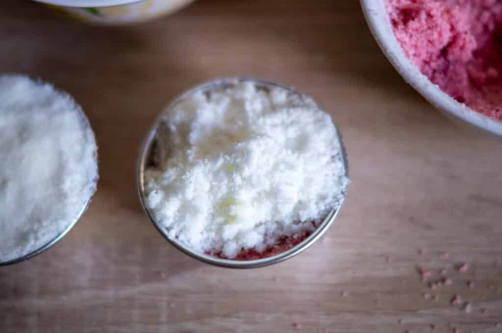 Filling bath bomb moulds in different coloured layers