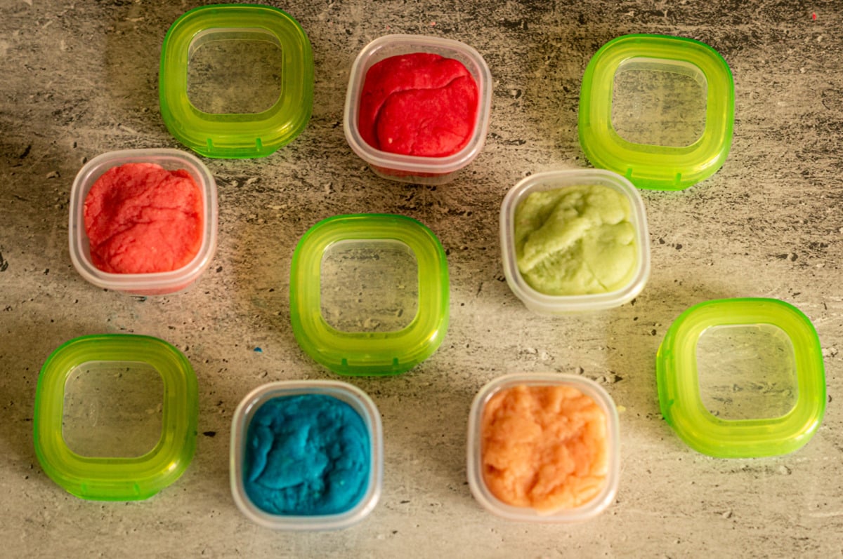 Filling play dough into storage containers