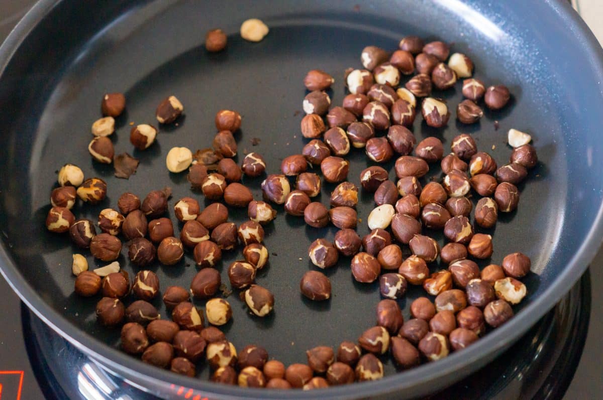 Toasting hazelnuts in a pan