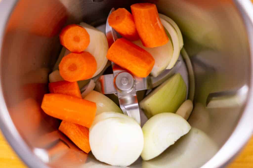 The vegetables being chopped in the mixing bowl