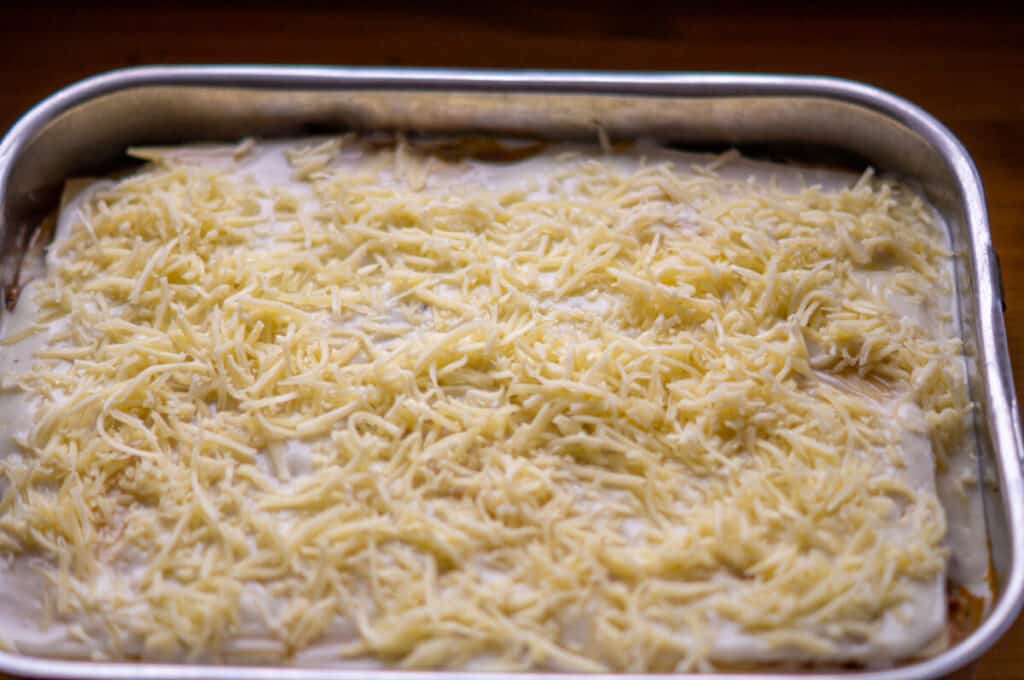 Top lasagne layer with cheese