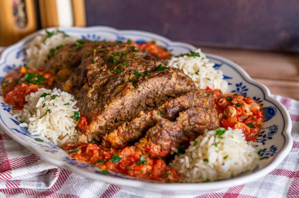 Juicy meatloaf made with the Thermomix® with red pepper and tomato sauce in a baking dish