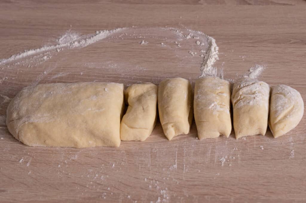 Dividing milk roll dough into ten equal pieces