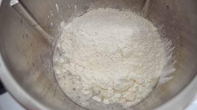 Yeast dough with flour in the Thermomix® mixing bowl