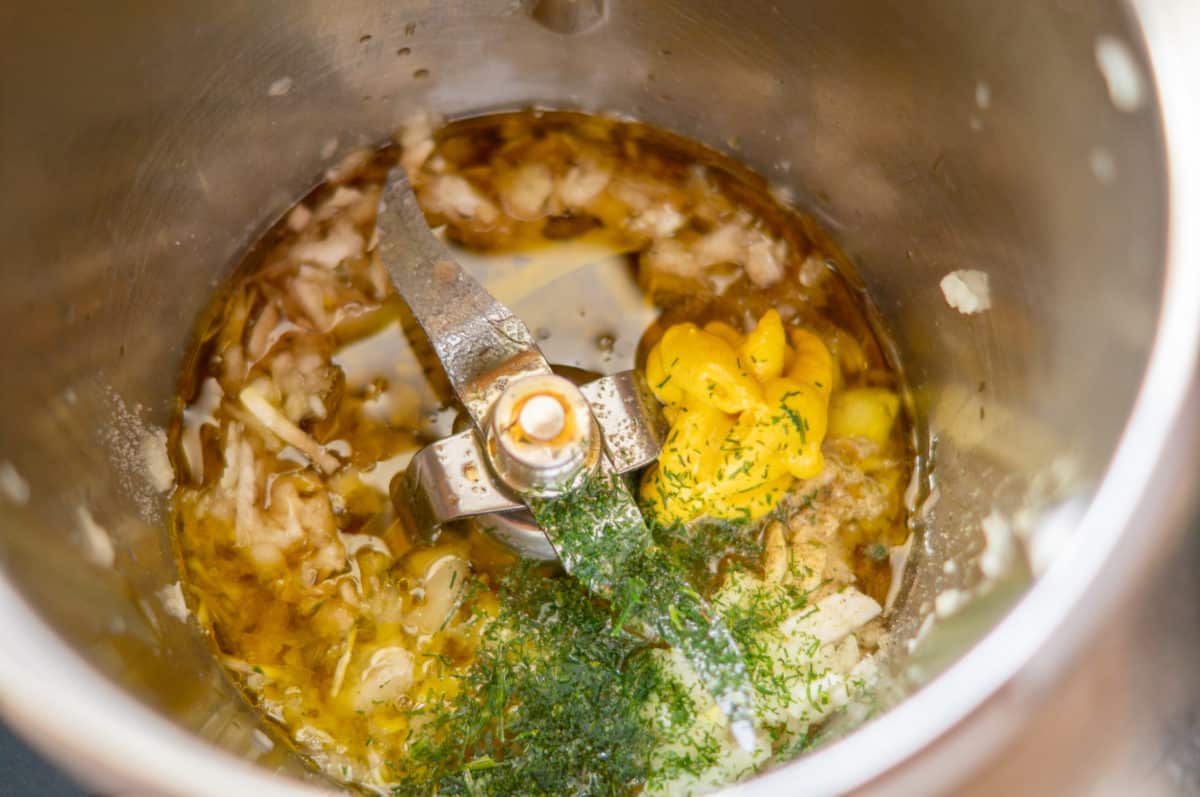 Dressing ingredients in the Thermomix®: oil, balsamic, onion, mustard