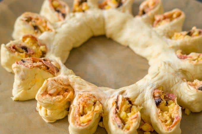 Pizza wreath made with the Thermomix®, scored and ready for the oven