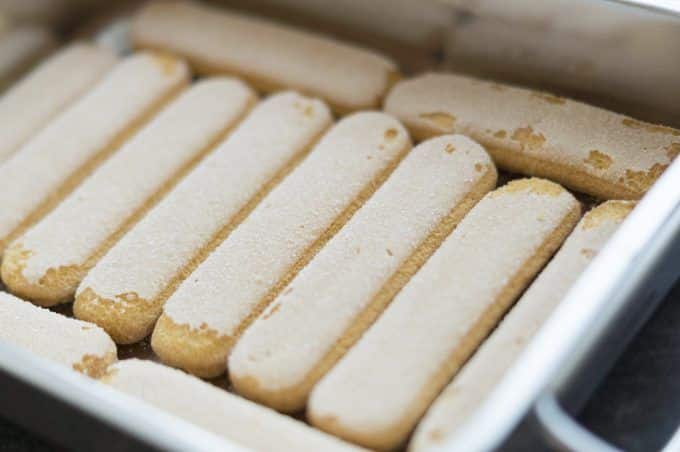 Laying the sponge fingers in the dish for the tiramisu
