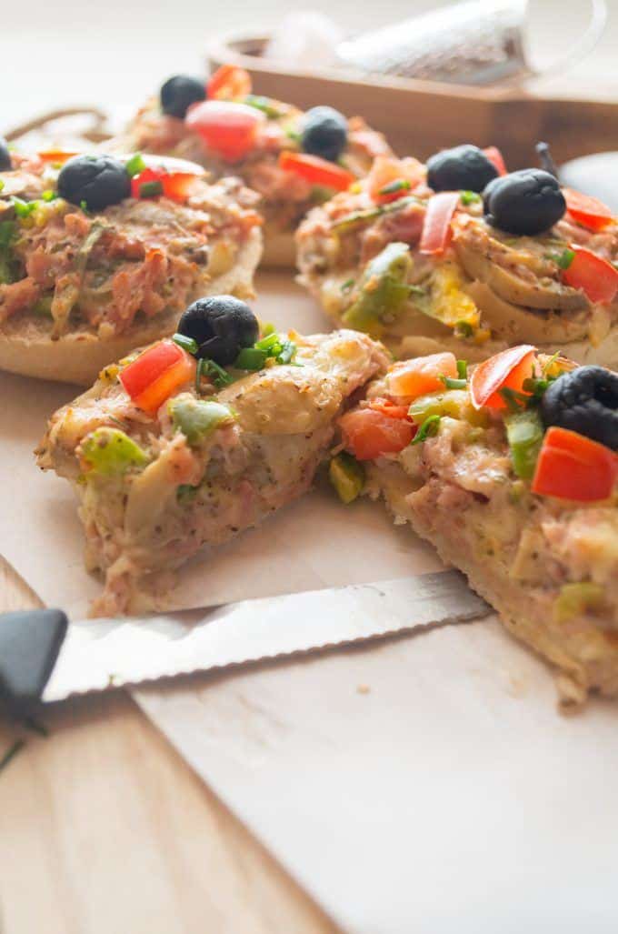 Pizza rolls made with the Thermomix® sliced open with Emmental cheese and cooked ham