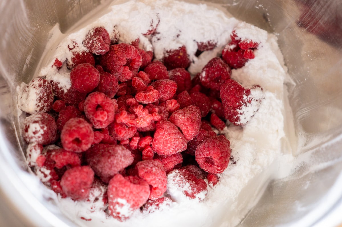 Raspberries and sugar in the Thermomix® mixing bowl