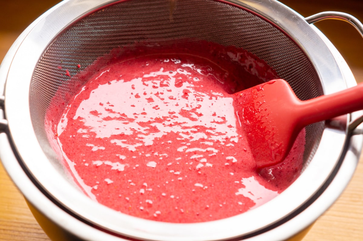Pressing berry mixture through a sieve