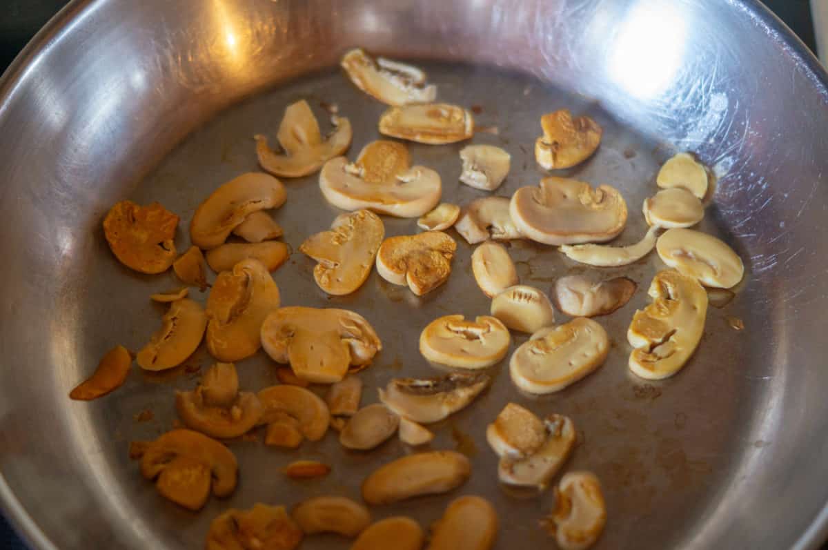 Searing mushrooms in a frying pan