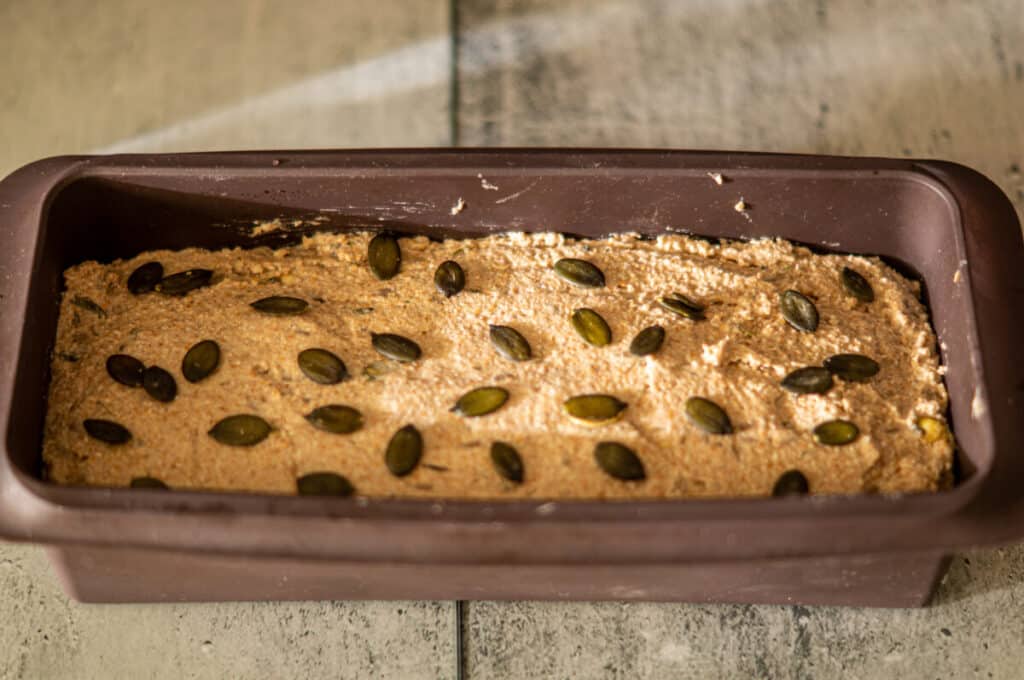 Wholegrain bread dough in a loaf tin