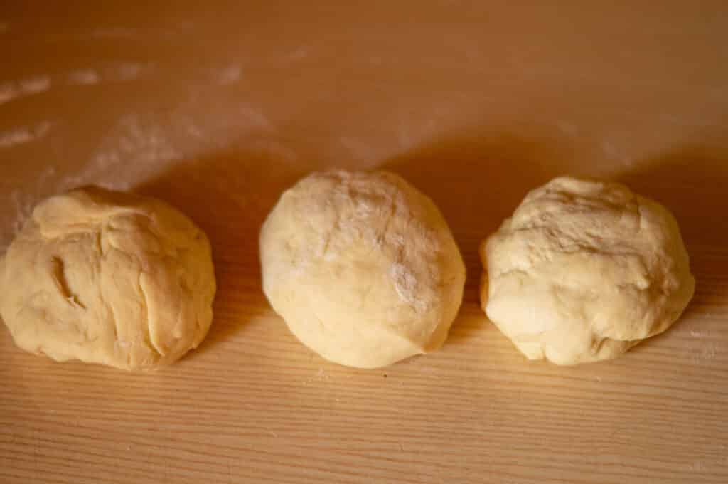 Dividing the yeast dough into three equal pieces for the Thermomix® plaited bread