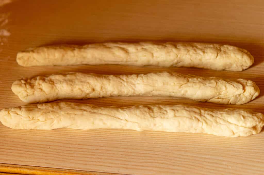 Rolling the yeast dough into three even strands