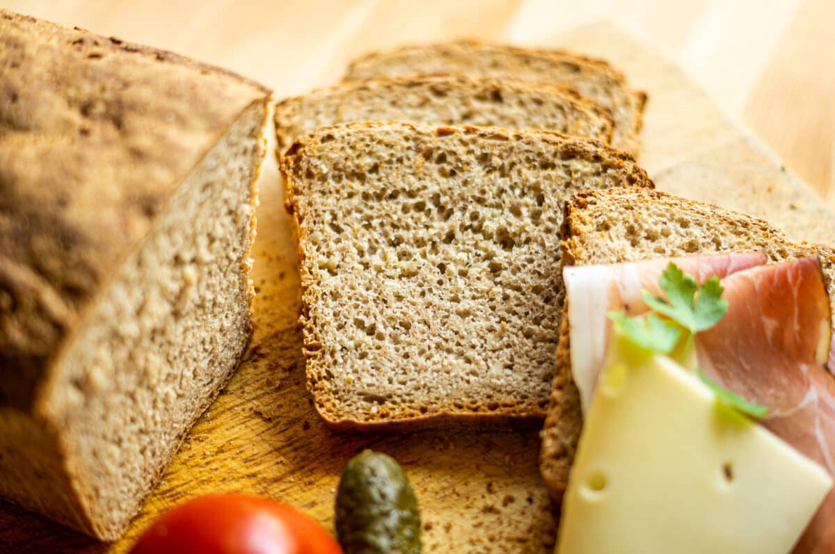 The Best Spelt Bread in the Thermomix® 2 Spelt bread baked in the Thermomix®, sliced on a wooden board
