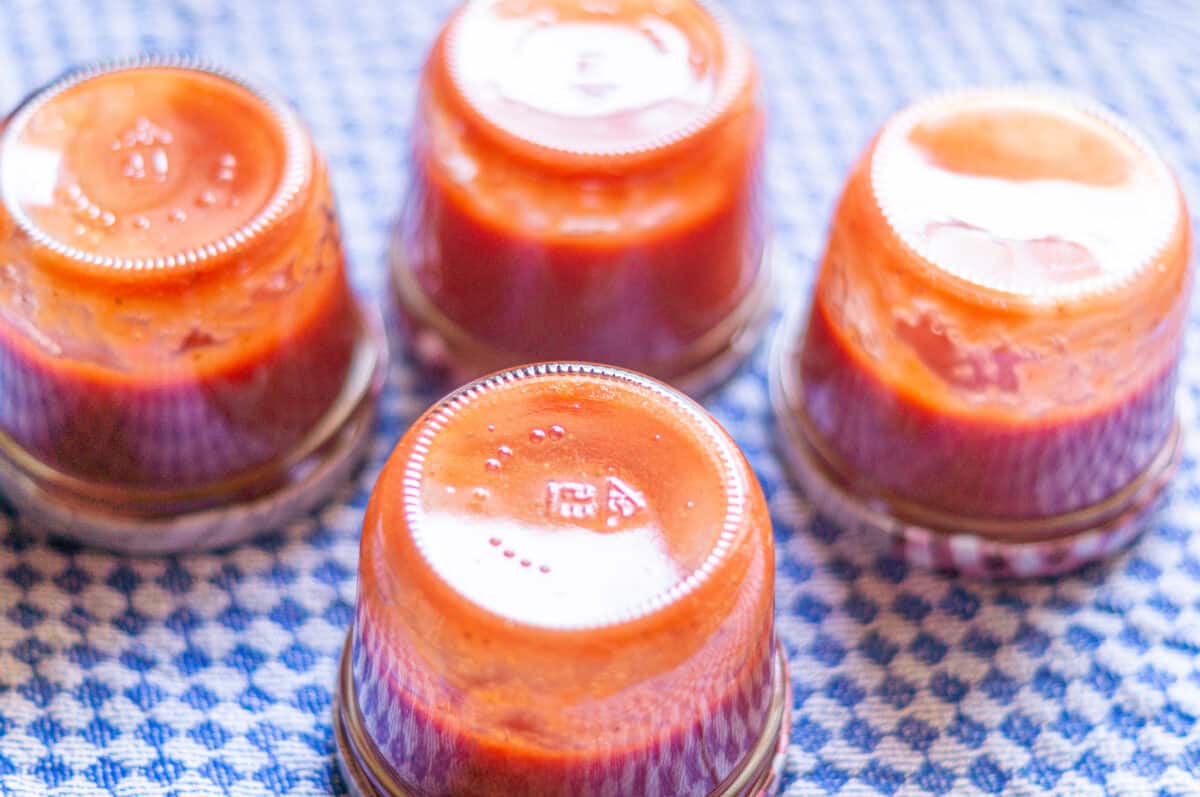 Strawberry ketchup jars turned upside down