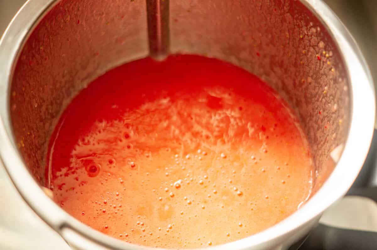 Blending strawberries in the mixing bowl