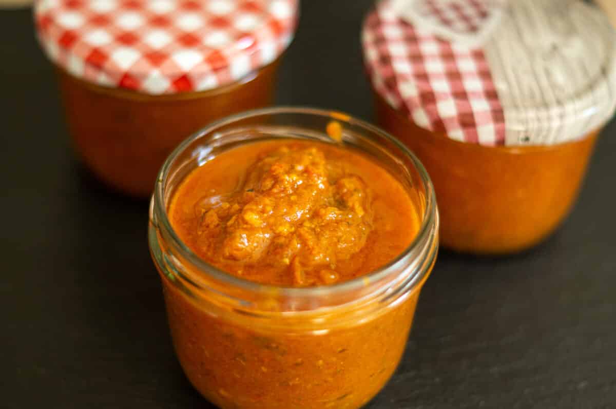 Filling Tomato and Date Chutney into sterilised preserving jars