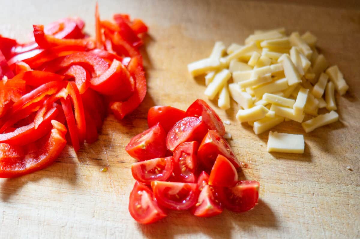Cutting cheese, tomatoes and pepper