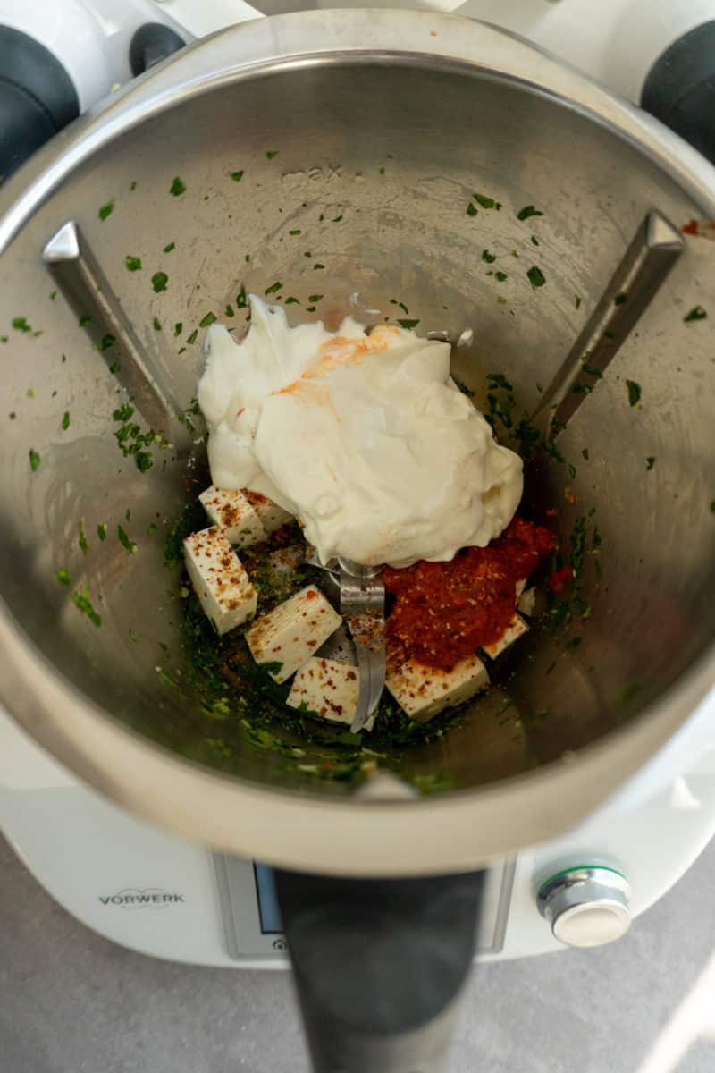 Feta, cream cheese, ajvar and spices in the mixing bowl before mixing at speed 4