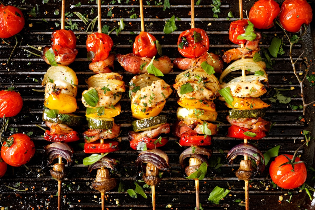 Colourful vegetable skewers with courgette, pepper, mushrooms and cherry tomatoes from the grill