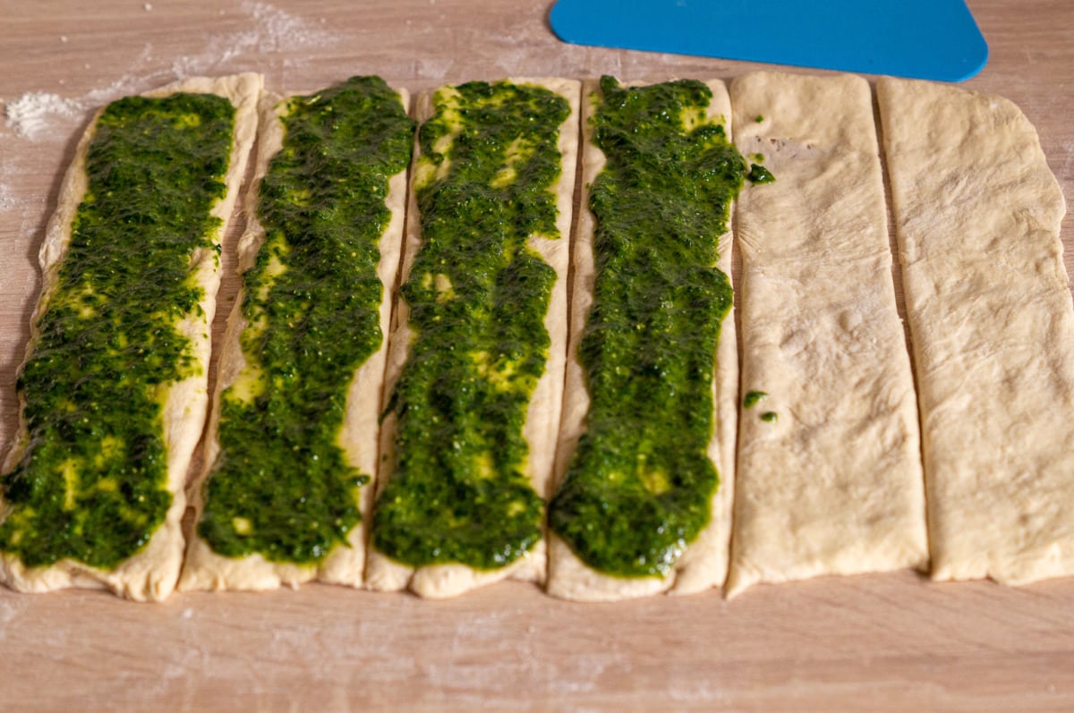 Dough rolled out, cut into strips and spread with the wild garlic mixture