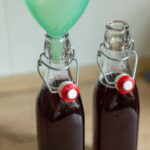 Two bottles of homemade cherry syrup